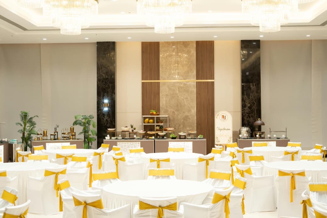 Buffet counters set against the marble and teak wall behind the dining tables