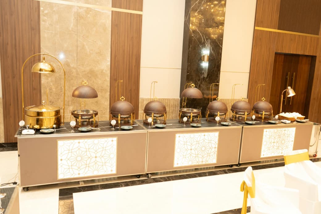 A row of domed chafing dishes on the hot buffet counter