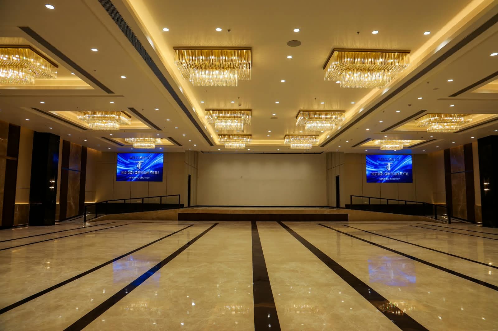 Antonios hall looking towards the stage, flanked by LED screens under rows of crystal chandeliers