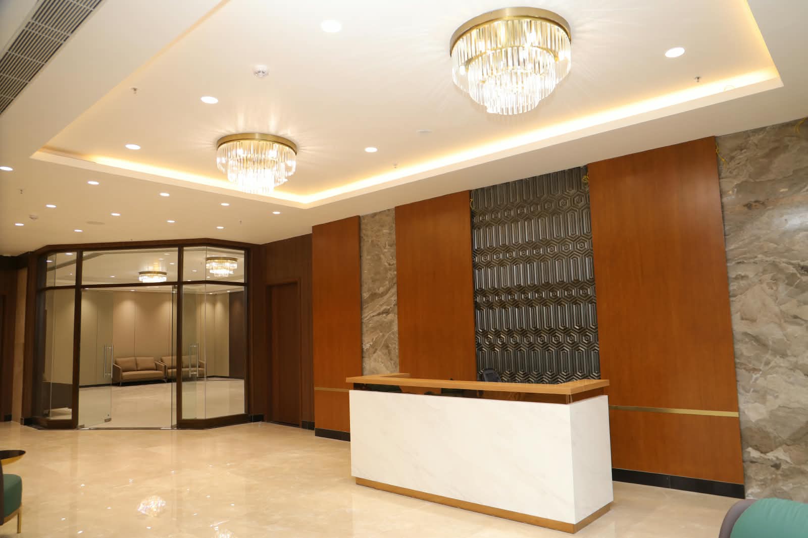 Reception desk on the second floor beside a glass-walled lounge