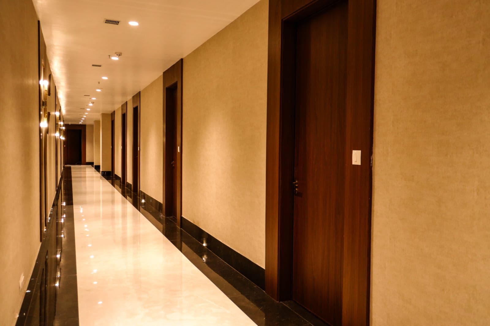 Panelled guest room doors lining the second floor corridor