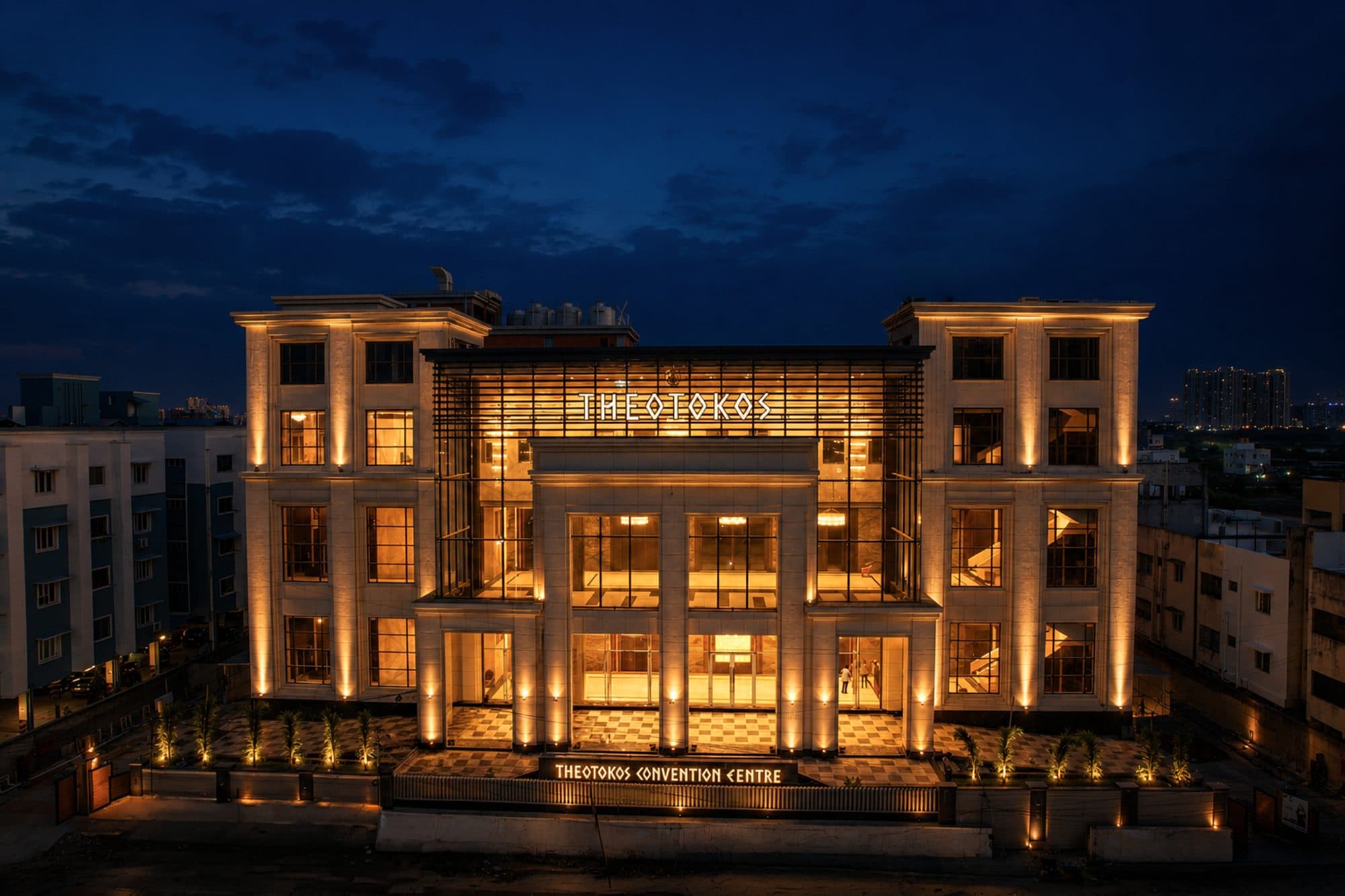 The lit facade of Theotokos Convention Centre at dusk